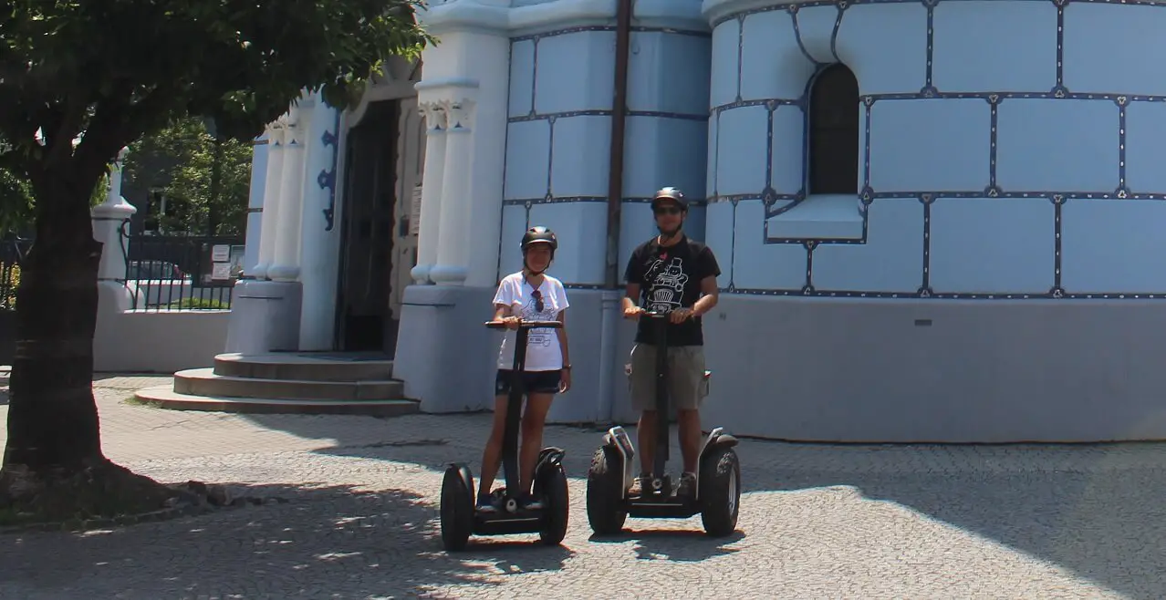 On Segway in front of the blue church