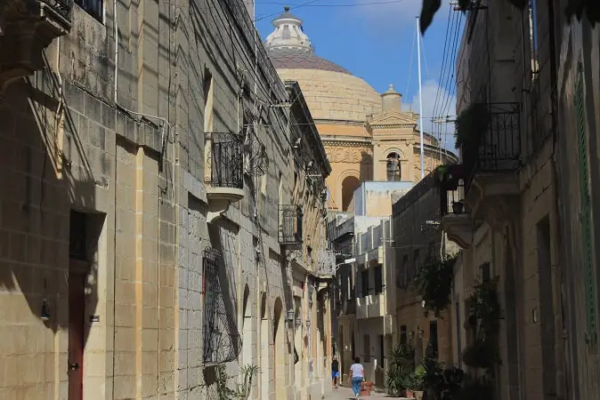 Honey colored houses and dome in Mosta